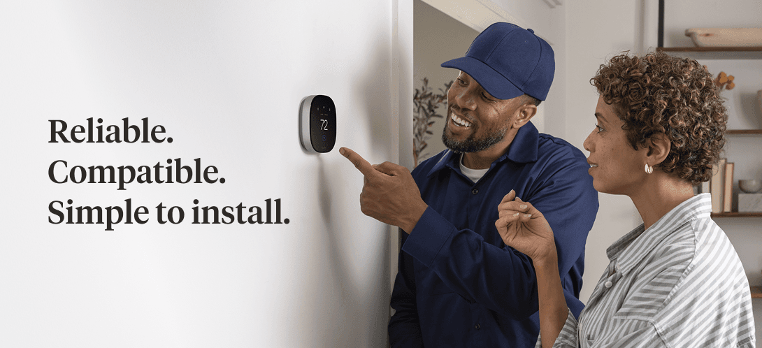 Man and woman pointing at an Ecobee Smart Thermostat